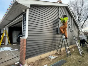 Siding Contractors Peoria IL 1 siding installation vinyl siding being installed on residential home by Portillo Construction, siding contractors Peoria IL trusts