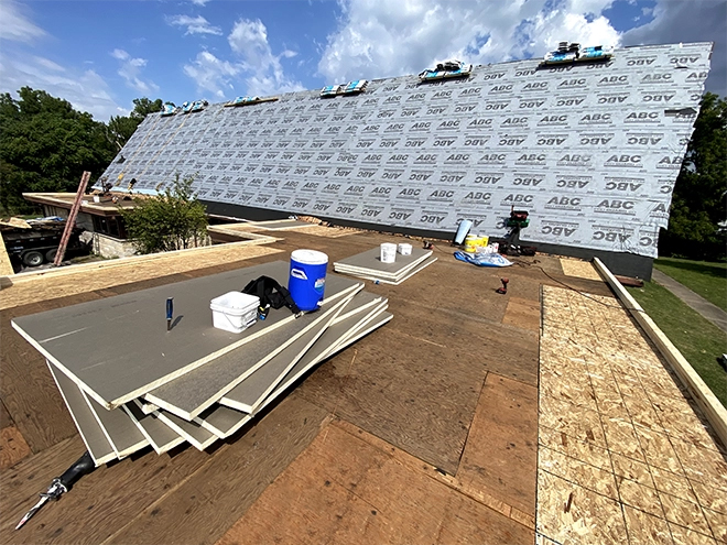 commercial roofing contractor installing flat roof system on commercial building